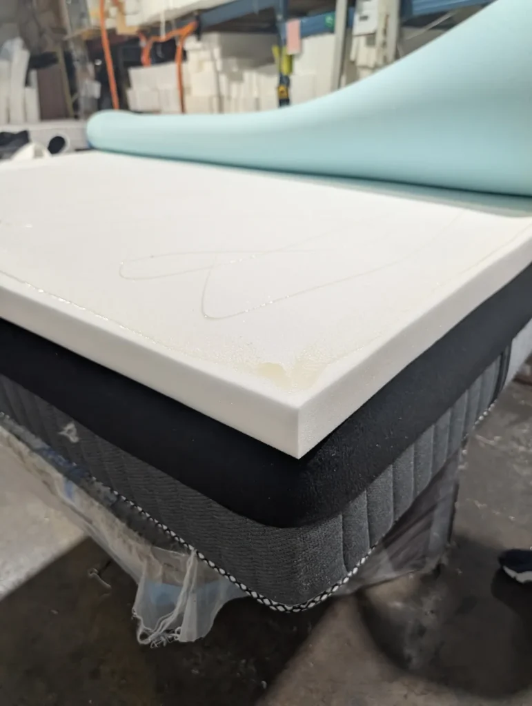 Mattresses in Toronto being built — high-density foam cut at our factory-direct production floor